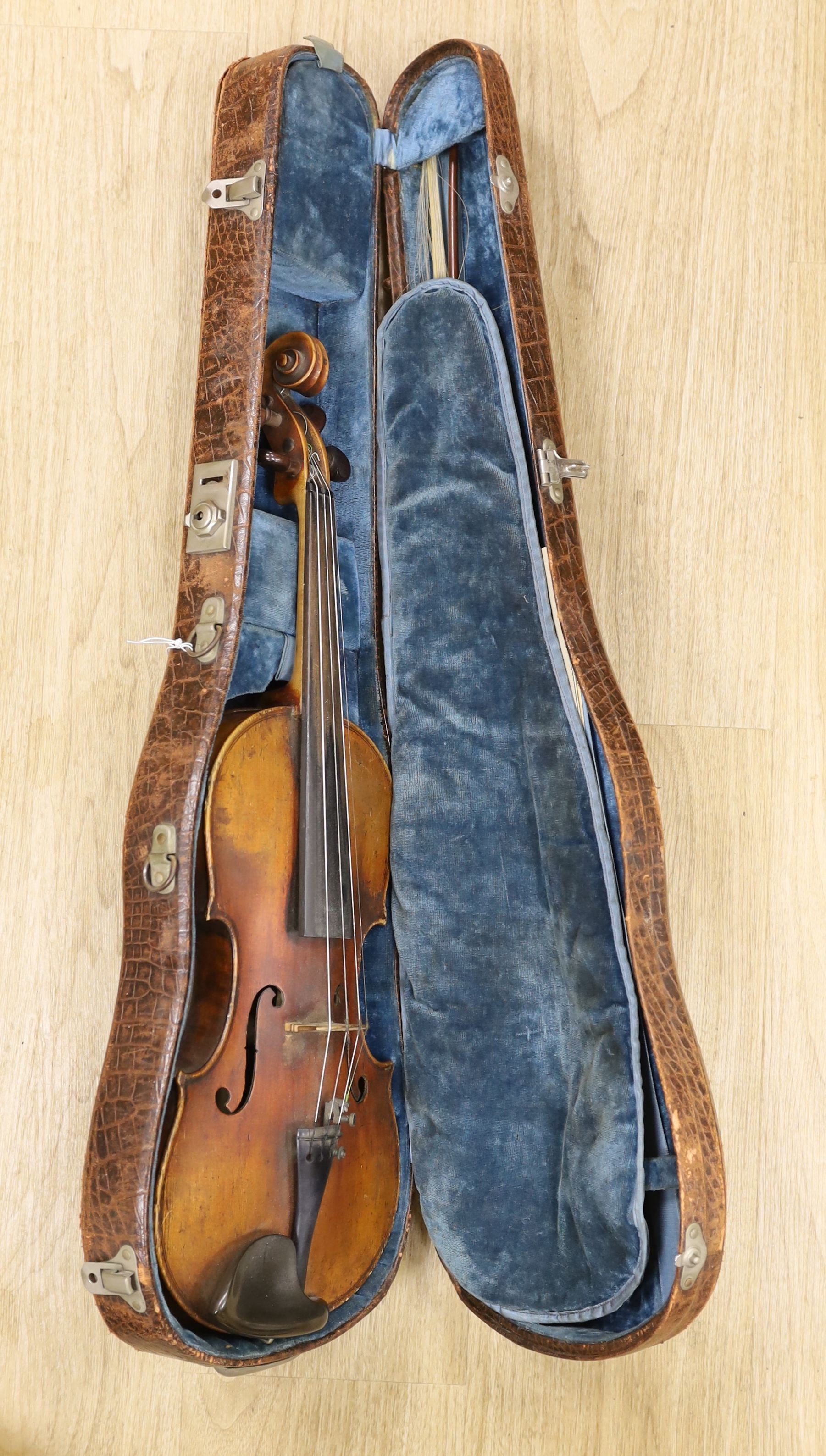 A 19th century violin with 14 inch 2 piece back, unlabelled, cased with silver mounted bow.